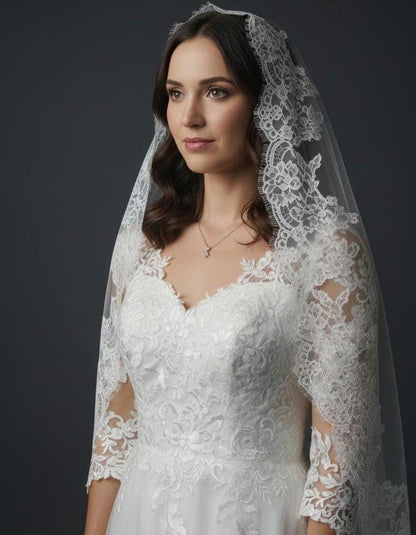 May include: A white wedding dress with a lace bodice and sleeves. The dress has a sweetheart neckline and is worn with a matching lace veil. A delicate necklace is visible.